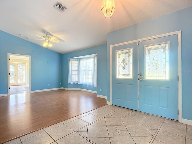 entrance foyer with french doors, light hardwood / wood-style floors, ceiling fan, and lofted ceiling