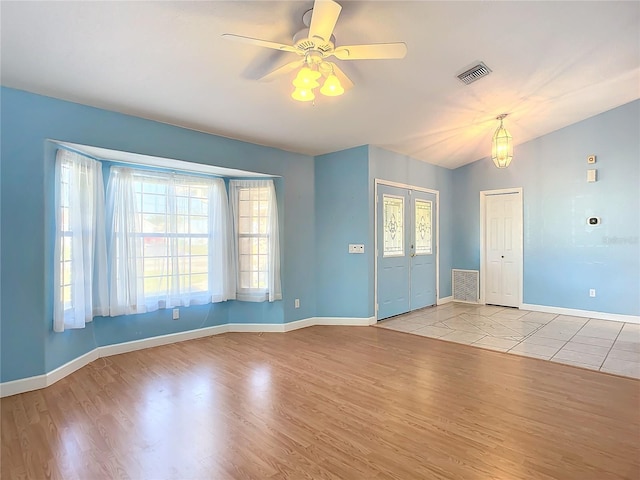 foyer featuring ceiling fan, light hardwood / wood-style floors, lofted ceiling, and french doors