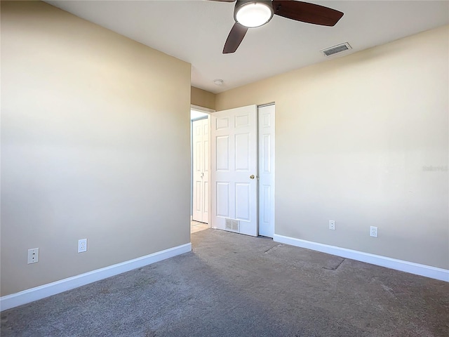 carpeted spare room featuring ceiling fan