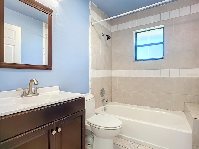 full bathroom featuring tile patterned floors, vanity, toilet, and tiled shower / bath