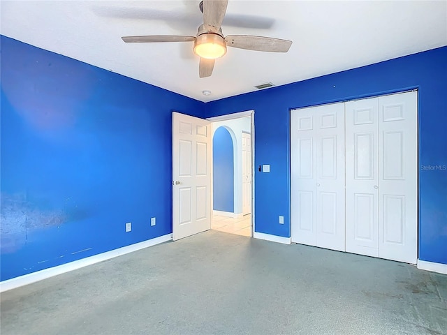 unfurnished bedroom with a closet and ceiling fan