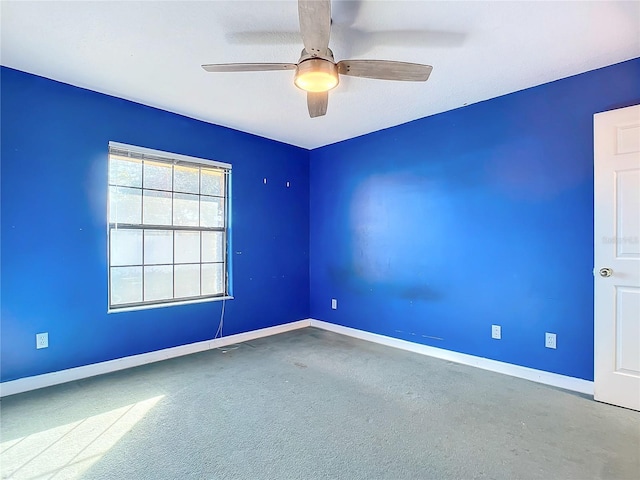 carpeted empty room with ceiling fan