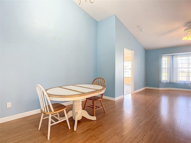 dining area with hardwood / wood-style flooring, ceiling fan, and lofted ceiling