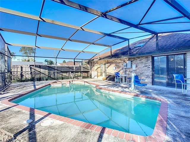 view of pool featuring glass enclosure and a patio