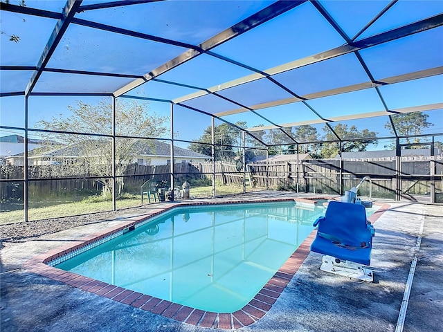 view of swimming pool featuring glass enclosure and a patio area