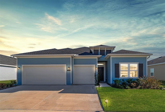 view of front of house featuring a yard and a garage