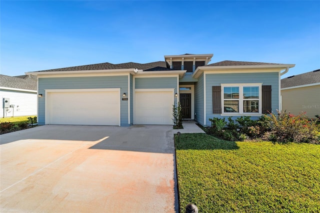 prairie-style house with a front yard and a garage