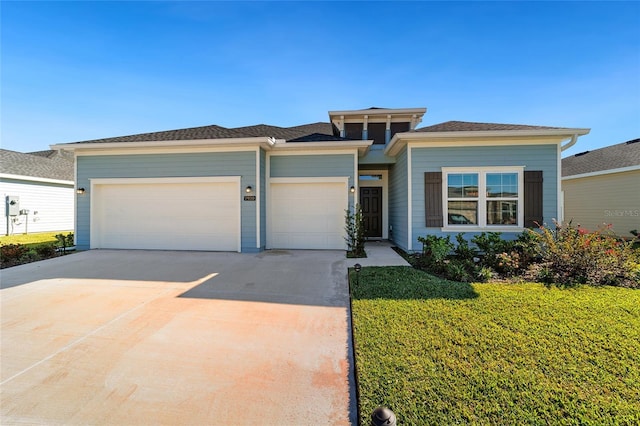 7930 SW 74th Loop, Ocala, FL 34481 - prairie-style home with an attached garage, concrete driveway, and a front yard