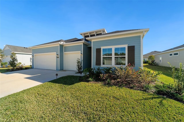 view of front of house featuring a garage and a front lawn