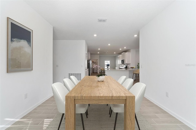 dining space with light hardwood / wood-style floors