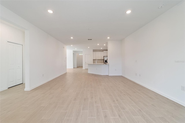 unfurnished living room with light hardwood / wood-style floors