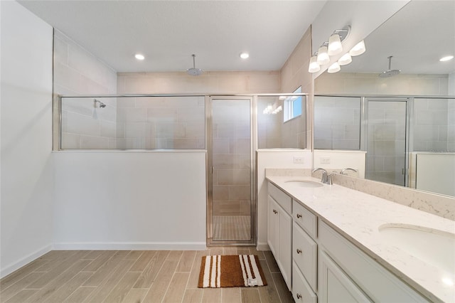 bathroom featuring vanity and a shower with door