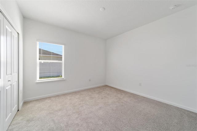 7930 SW 74th Loop, Ocala, FL 34481 - unfurnished bedroom featuring light carpet, baseboards, and a closet