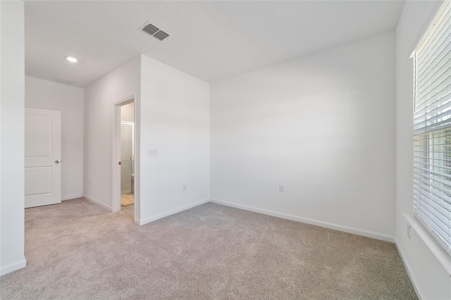 unfurnished room with light carpet