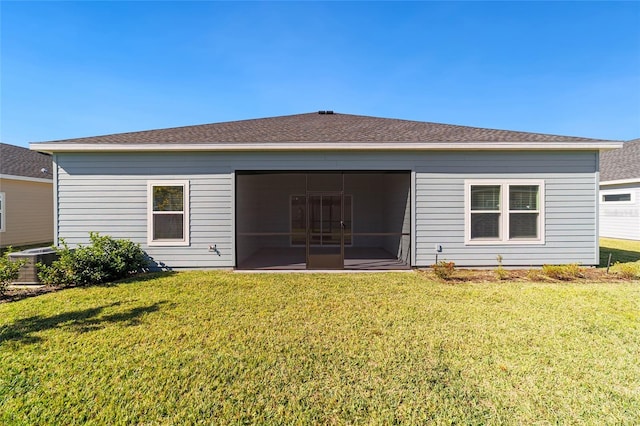 7930 SW 74th Loop, Ocala, FL 34481 - back of house featuring a lawn, a sunroom, cooling unit, and roof with shingles