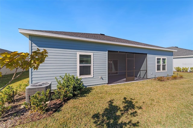 7930 SW 74th Loop, Ocala, FL 34481 - back of house with central AC, a lawn, and a sunroom