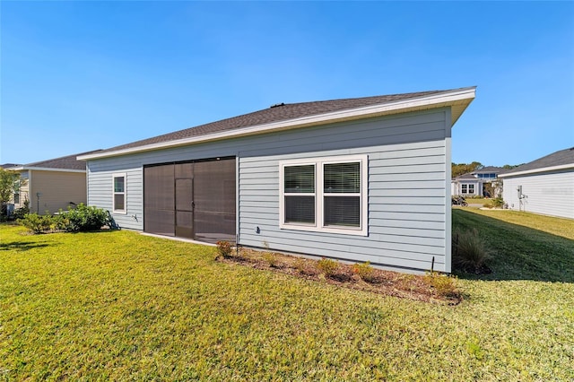 rear view of property with a yard