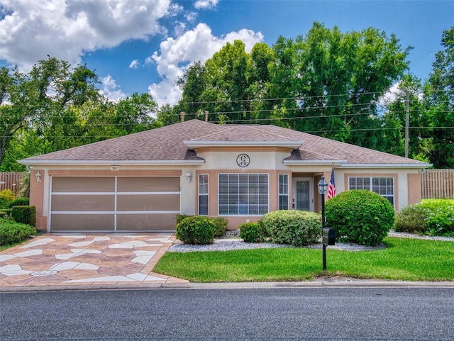 view of front of home with a front yard and a garage