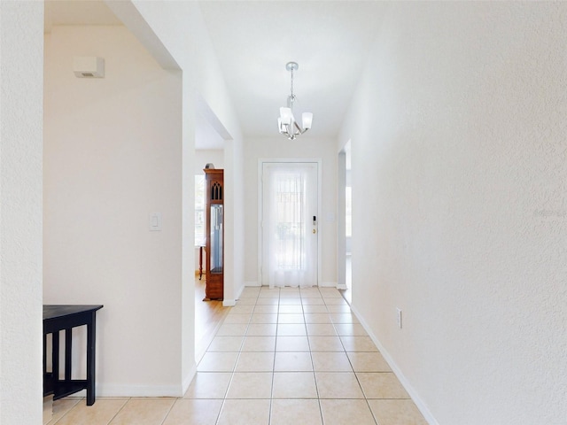 tiled foyer entrance featuring a chandelier