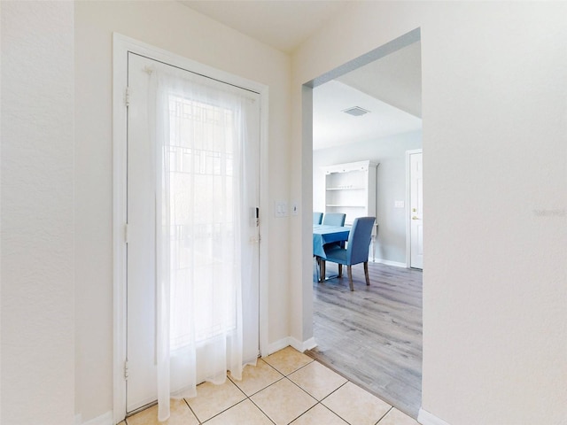 hallway with light hardwood / wood-style flooring