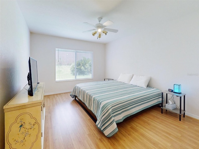 bedroom with ceiling fan and hardwood / wood-style floors