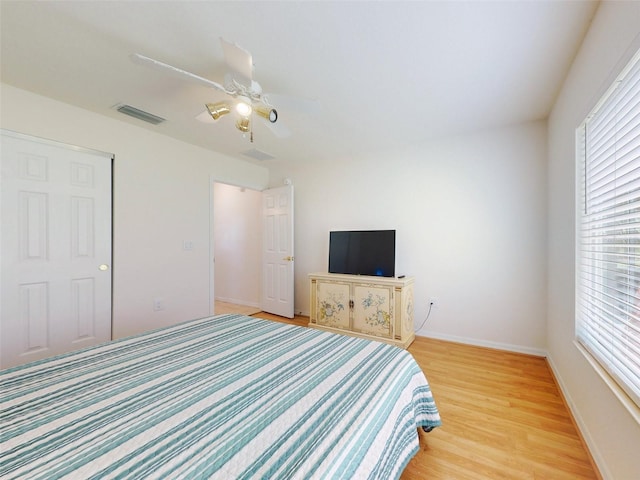 bedroom with ceiling fan and light wood-type flooring