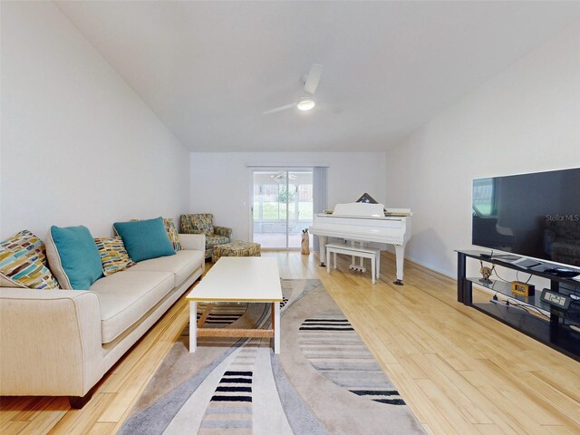 living room featuring ceiling fan and light hardwood / wood-style flooring