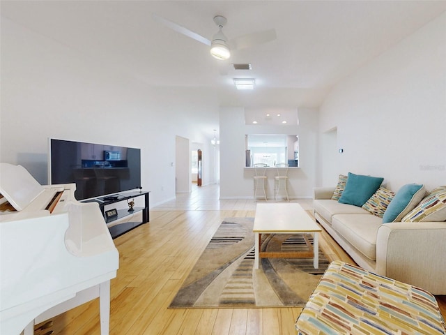 living room with ceiling fan and wood-type flooring