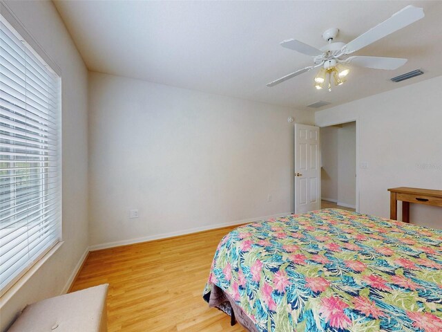 bedroom with ceiling fan and light hardwood / wood-style floors