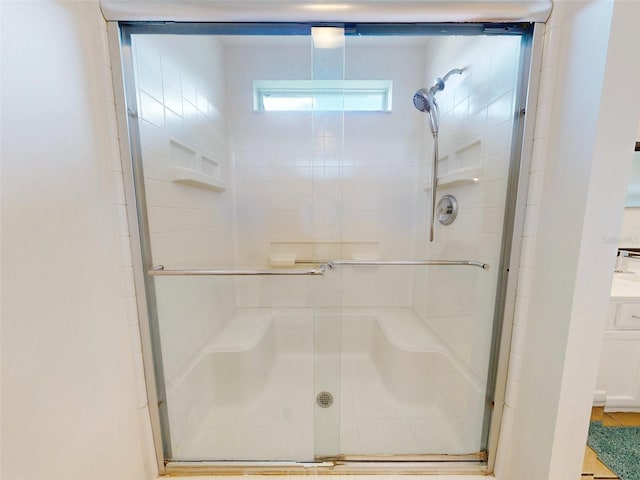 bathroom with a shower with door