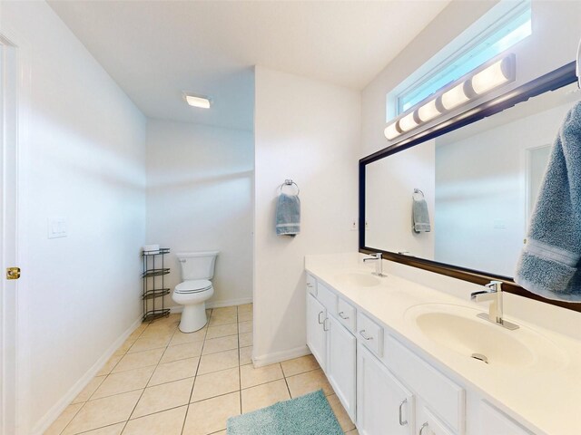 bathroom featuring tile patterned flooring, vanity, and toilet