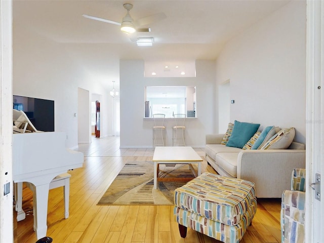 living room with ceiling fan and light wood-type flooring