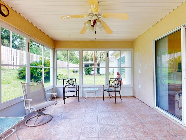 sunroom with a wealth of natural light and ceiling fan