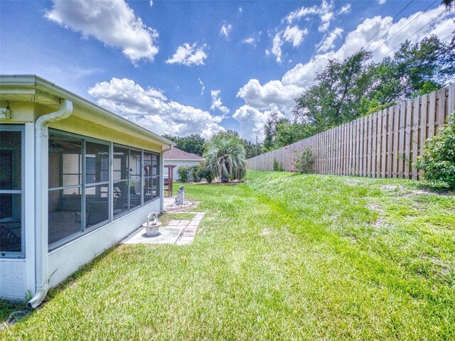 view of yard with a sunroom