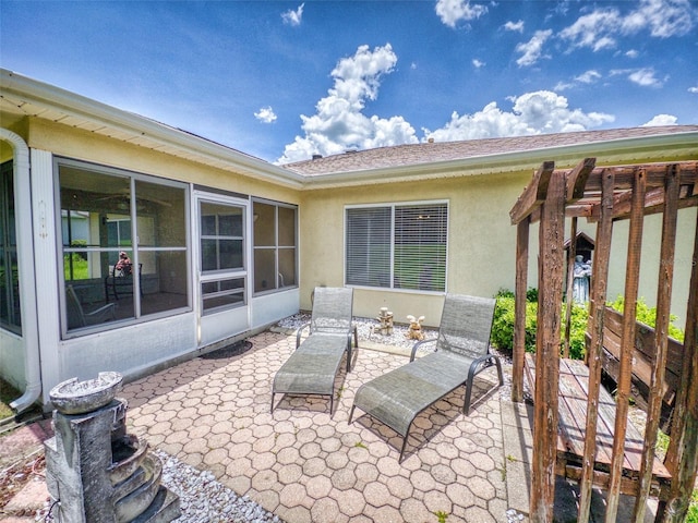 view of patio featuring a sunroom