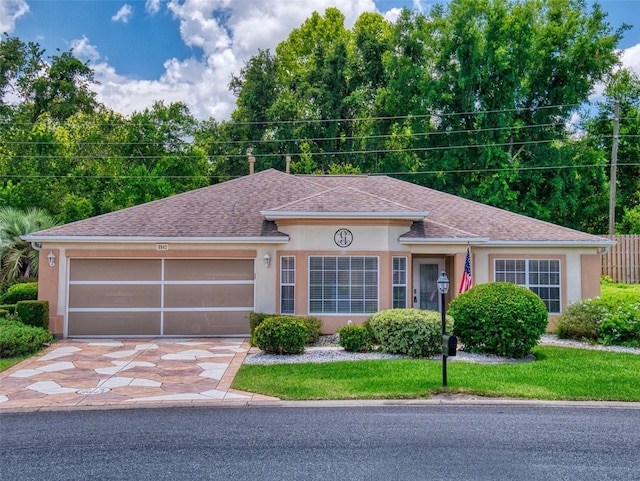 view of front of property with a garage and a front lawn