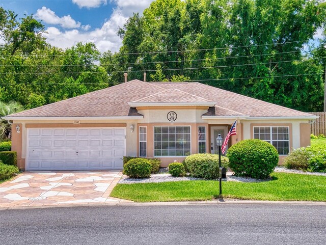 view of front facade with a front lawn and a garage