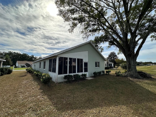 back of property with a lawn