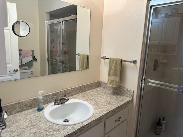 bathroom featuring vanity and a shower with door