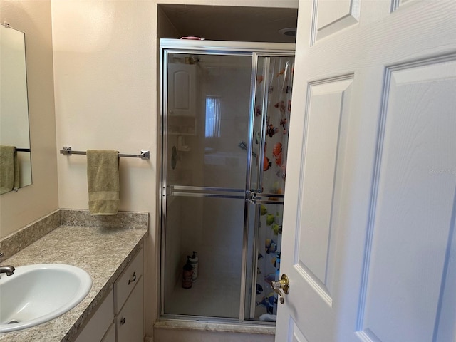 bathroom with vanity and a shower with shower door