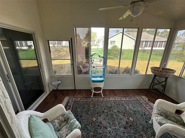 sunroom with ceiling fan and lofted ceiling