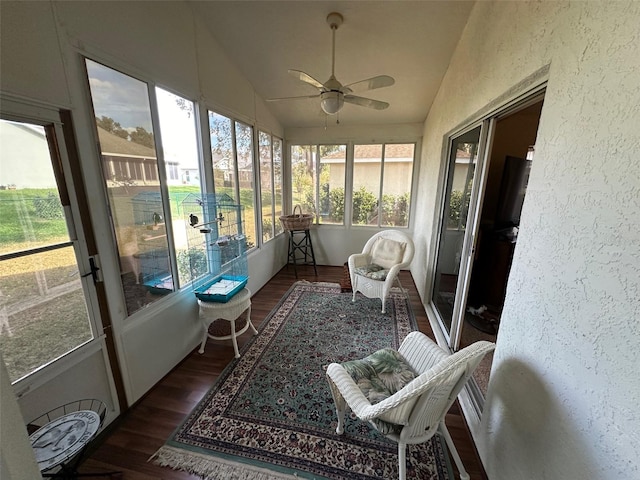 sunroom with ceiling fan and vaulted ceiling