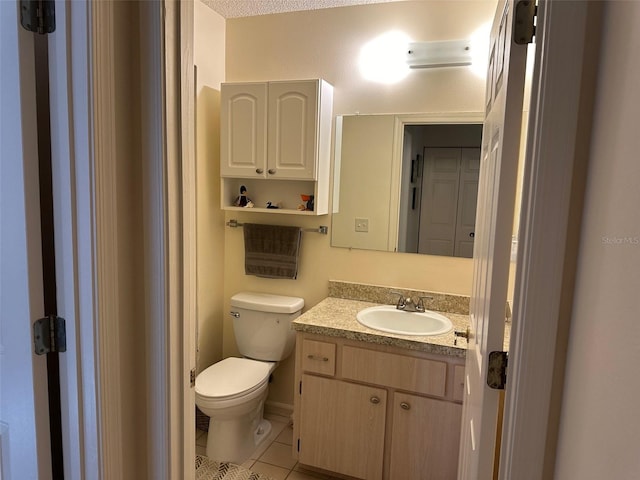 bathroom featuring tile patterned floors, vanity, a textured ceiling, and toilet