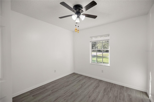 empty room featuring ceiling fan, wood-type flooring, and a textured ceiling