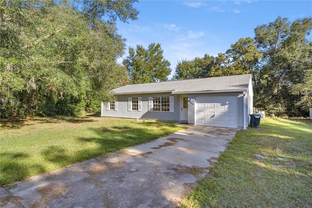 ranch-style house featuring a garage and a front lawn