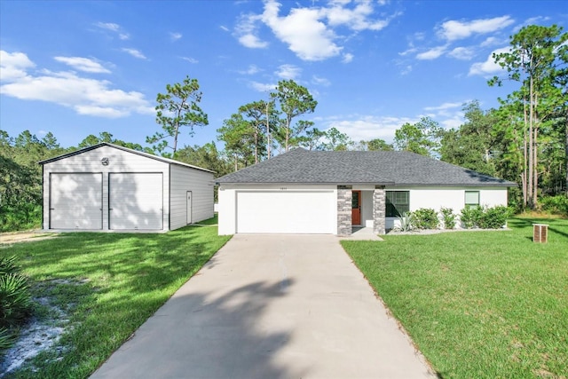 view of front of property featuring a front yard, an outbuilding, and a garage