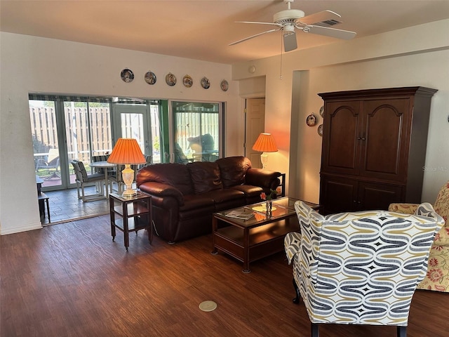 living room featuring ceiling fan and dark hardwood / wood-style floors