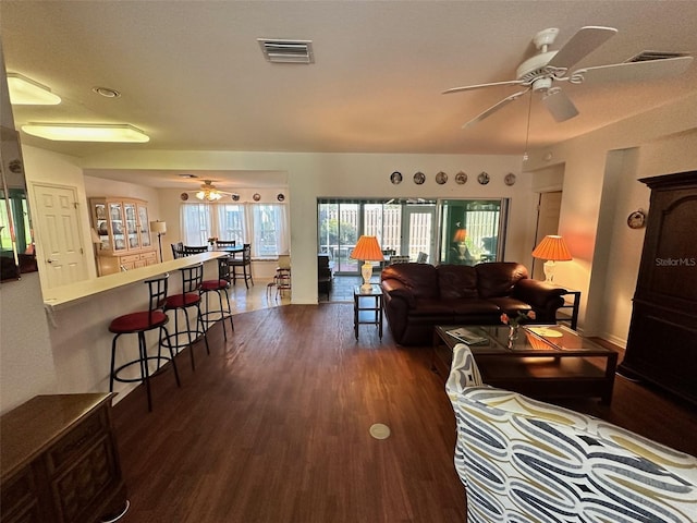 living room featuring dark hardwood / wood-style floors and ceiling fan