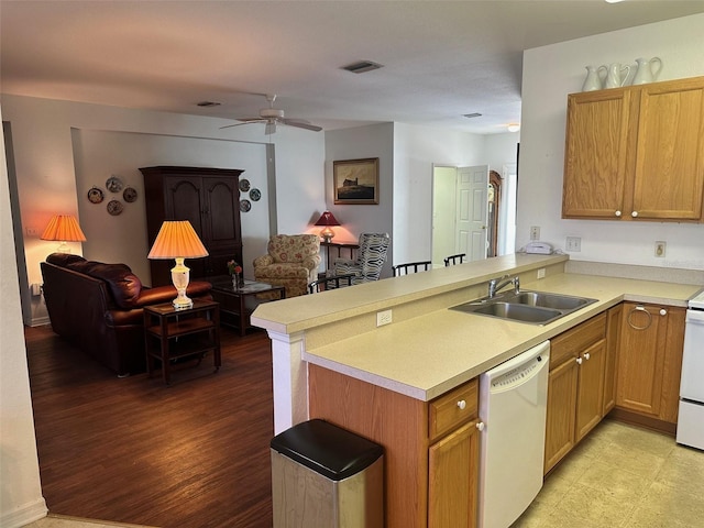 kitchen featuring kitchen peninsula, sink, white appliances, and light hardwood / wood-style flooring