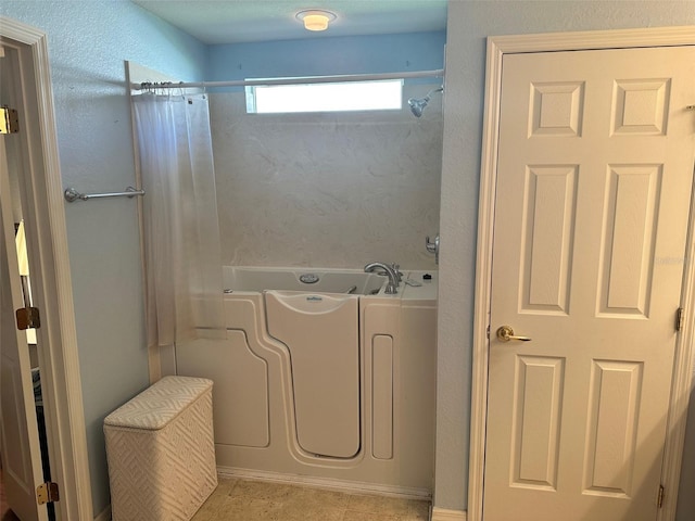 bathroom with tile patterned flooring and shower with separate bathtub